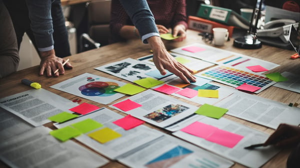 Documents on a table laid out in a clear plan for Quarterly Business Reviews (QBRs)