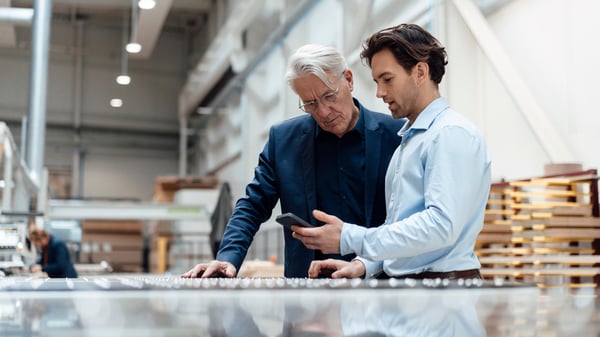 Two business men discuss the added value of their supplier after their Quarterly Business Reviews (QBRs)