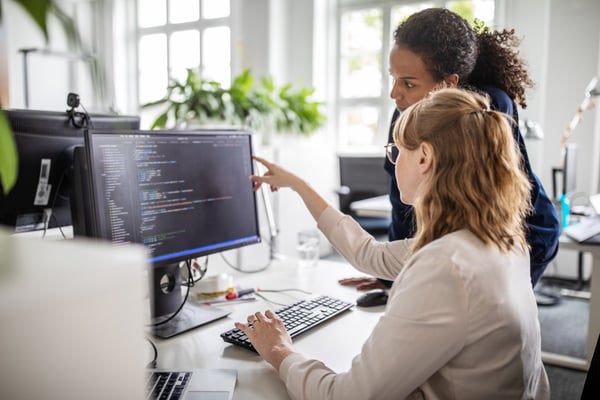 Two people looking at a computer screen